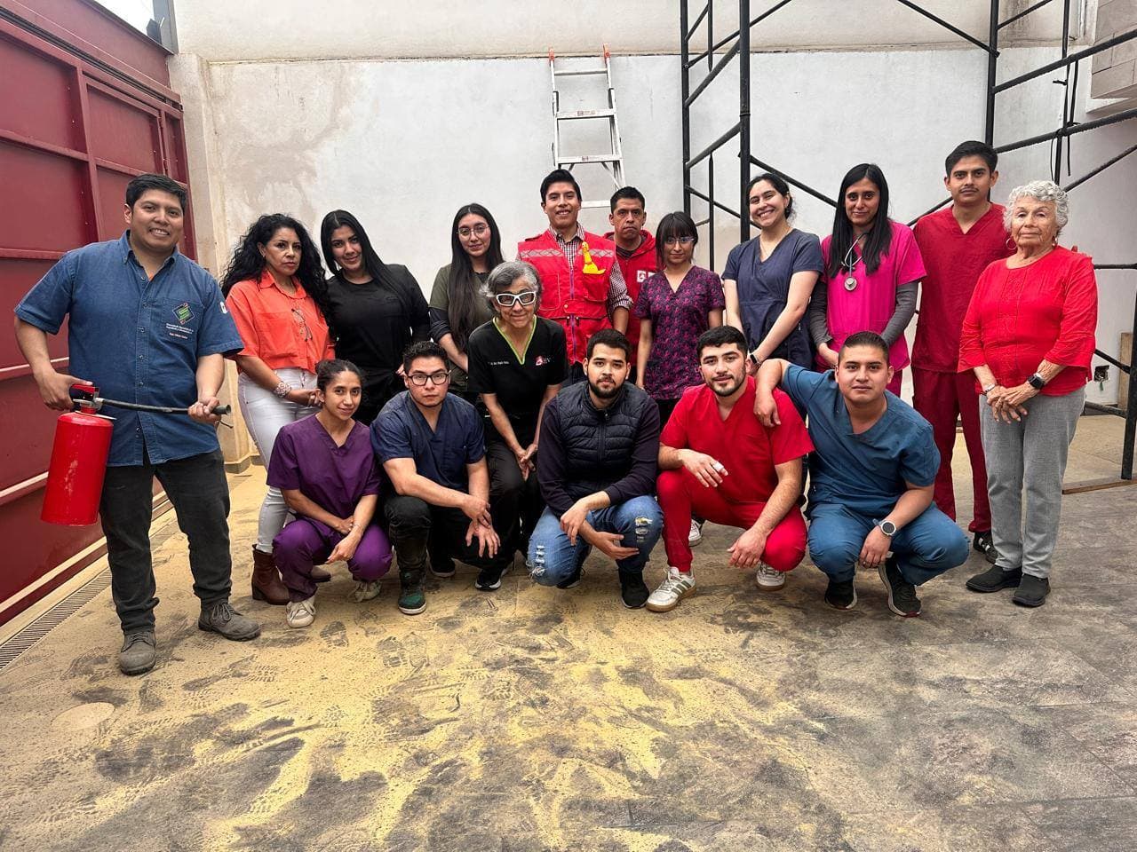 Equipo de una clínica reunido con extintores al finalizar su capacitación de brigada